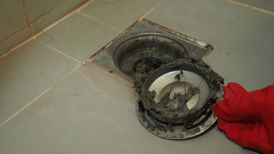 Drain Cleaning Clogged And Dirty Sewer Pipes Floor Drain. Drain cleaning. Clogged and dirty sewer pipes floor drain. Full of hair and accumulated clogged grease. Maintenance the floor drain sewage system in bathroom. fixing clean wash and unclog a drain.