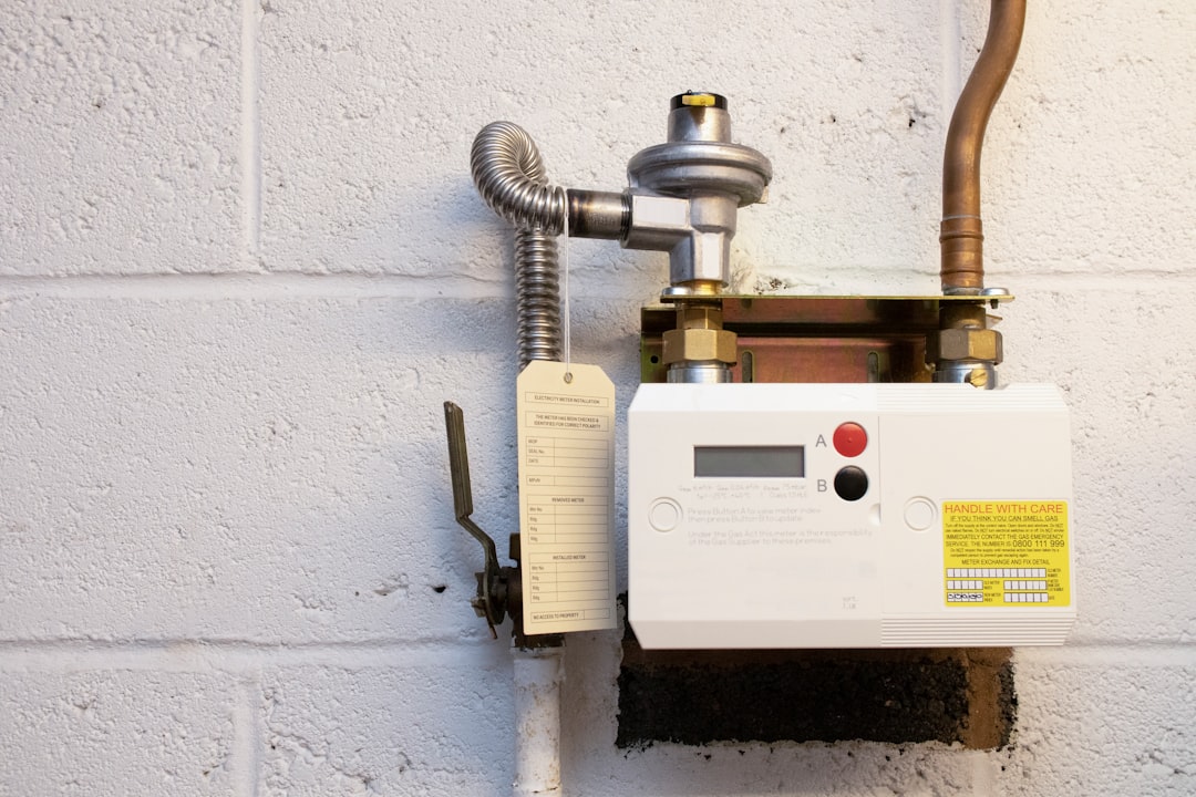 A modern tankless water heater installed in a clean utility room A modern tankless water heater installed in a clean utility room