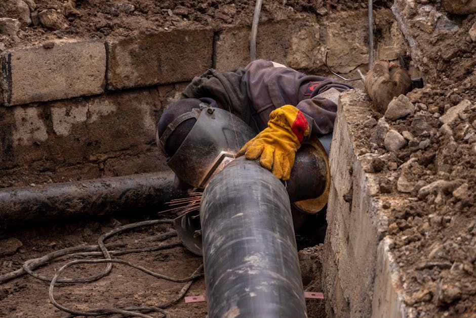 Emergency pipe repair being performed by a licensed plumber Emergency pipe repair being performed by a licensed plumber